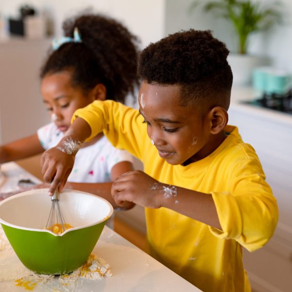 african american siblings baking in kitchen